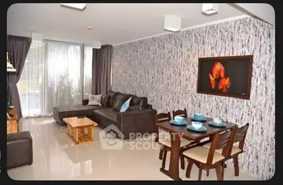 Stylish living room with modern decor and dining area, featuring a cozy sofa and elegant dining set.