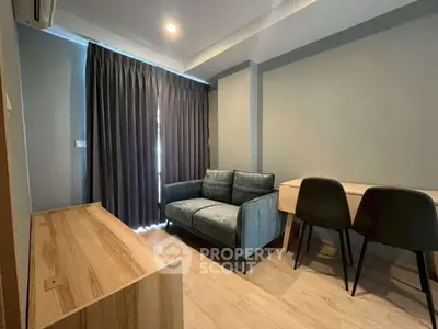 Modern living room with cozy sofa and stylish furniture, perfect for relaxation and work.