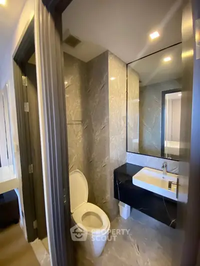 Modern bathroom with sleek design and elegant fixtures in a contemporary apartment.