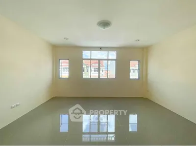 Spacious empty room with large windows and glossy tiled floor, perfect for customization.