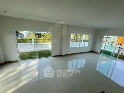 Spacious living room with large windows and garden view