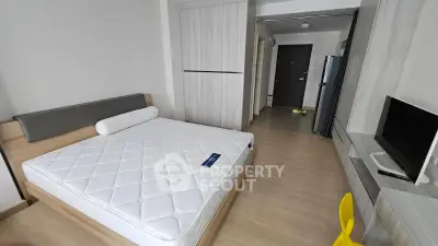 Modern bedroom with sleek design, featuring a comfortable bed, stylish wardrobe, and a flat-screen TV for ultimate relaxation.