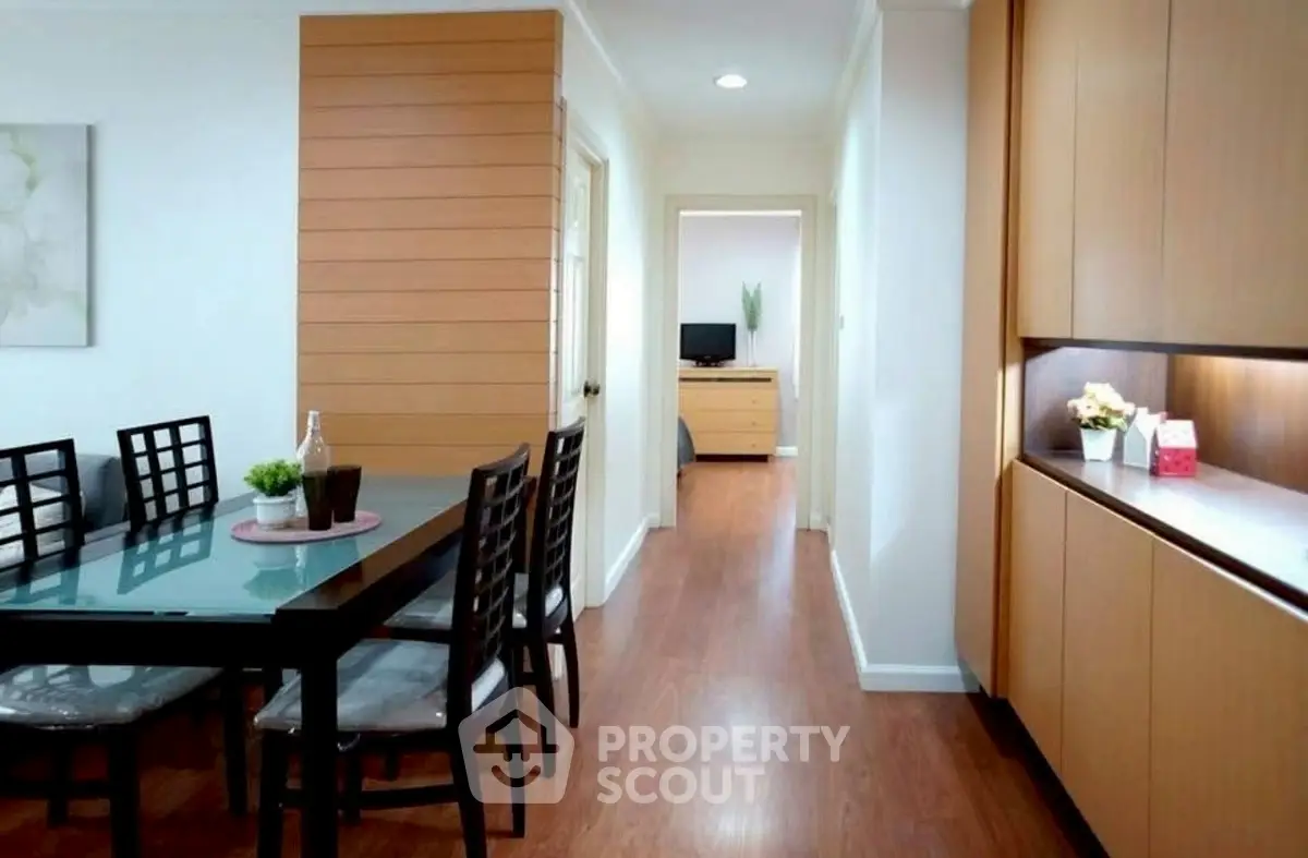 Modern dining area with wooden flooring and sleek cabinetry