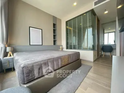 Luxurious modern bedroom with plush bed and stylish decor in high-rise apartment.