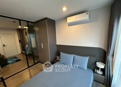 Modern bedroom with sleek design and air conditioning in a stylish apartment.