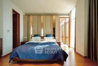 Luxurious bedroom with elegant decor and natural light in modern real estate property.