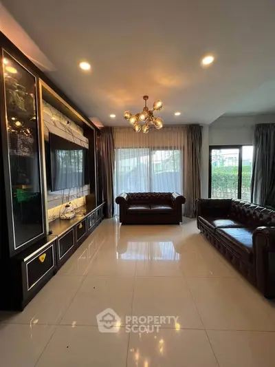 Luxurious living room with elegant leather sofas and modern lighting, perfect for relaxation and entertainment.