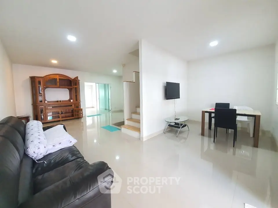 Spacious modern living room with sleek furniture and open layout, perfect for family gatherings.