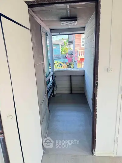 Charming small balcony with urban view, perfect for relaxing and enjoying city life.