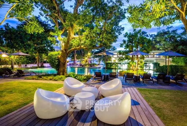 Luxurious garden view with modern outdoor seating and poolside ambiance.