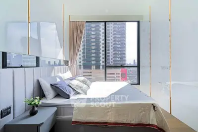 Bright modern bedroom with large window offering stunning city view, featuring elegant decor and cozy bedding.