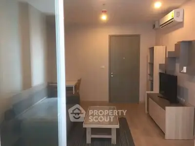 Modern living room with sleek furniture and air conditioning in a cozy apartment.
