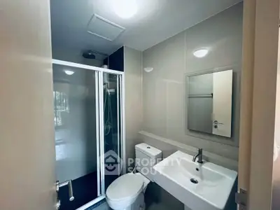 Modern bathroom with sleek shower and contemporary fixtures in a stylish apartment.