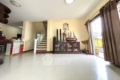 Spacious living room with staircase and natural light in modern home