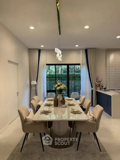 Elegant dining room with modern decor and large window view