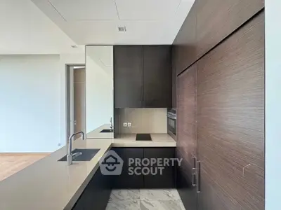 Modern kitchen with sleek dark cabinets and built-in appliances