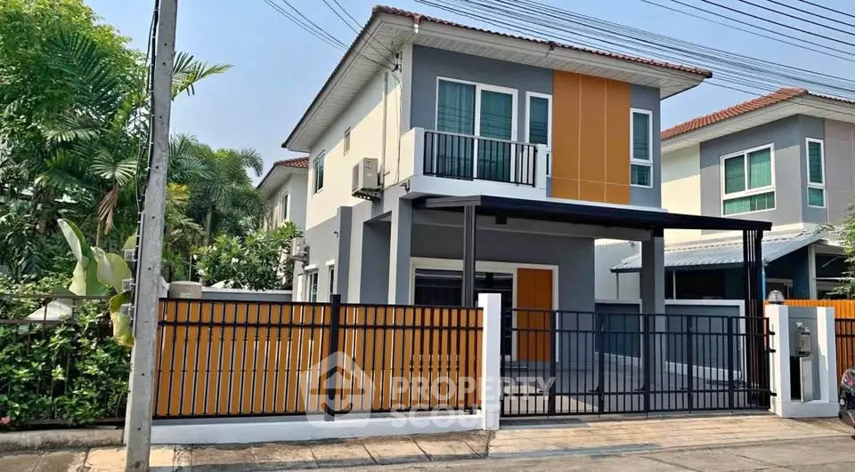 Modern two-story house with gated entrance and stylish facade