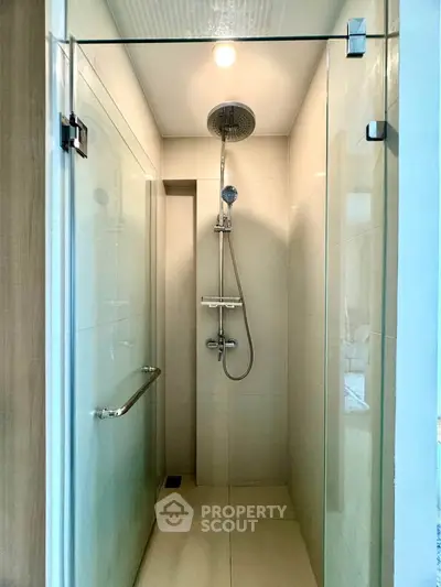 Modern bathroom shower with glass enclosure and sleek fixtures.