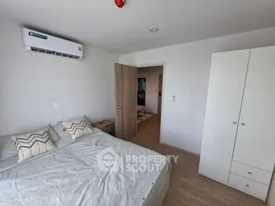 Modern bedroom with air conditioning and minimalist decor in a stylish apartment.