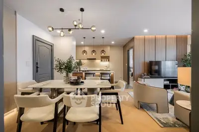 Modern open-plan living and dining area with stylish lighting and contemporary furniture.