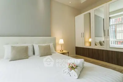 Elegant bedroom with modern decor and ample natural light