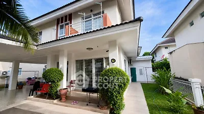 Charming two-story house with lush garden and spacious patio in a serene neighborhood.