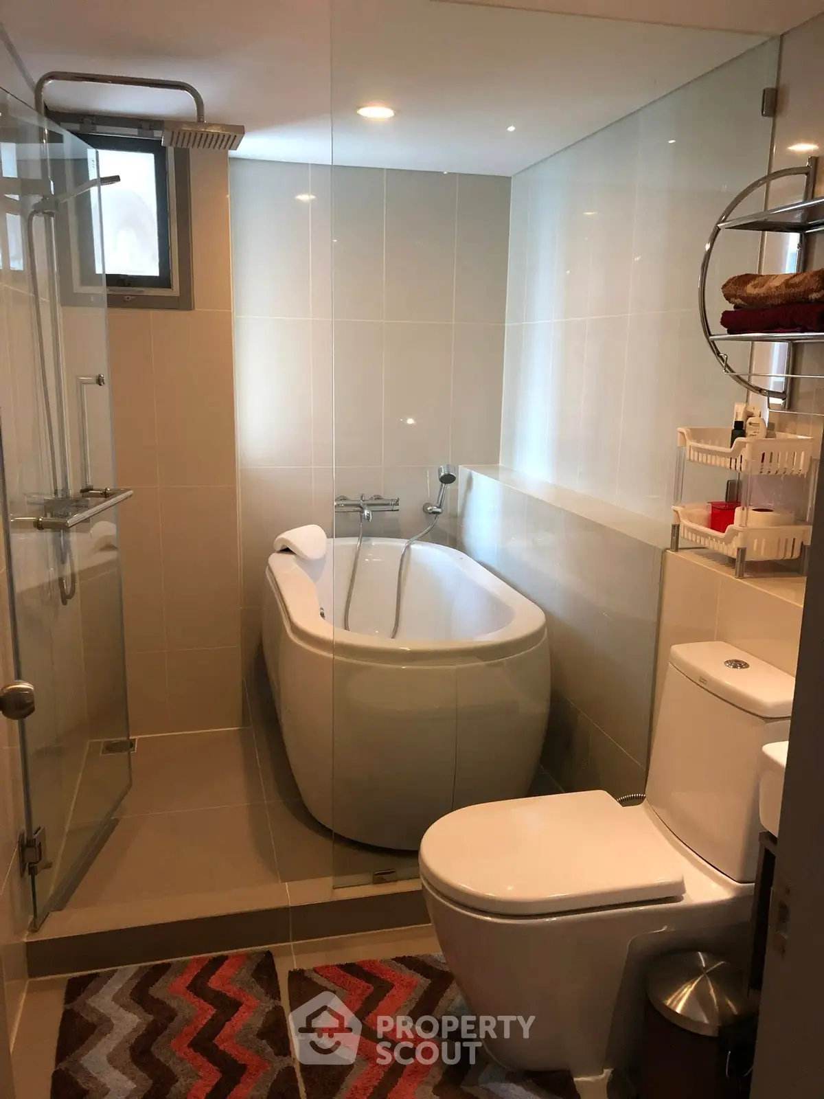 Modern bathroom with sleek design featuring a bathtub and glass shower enclosure.