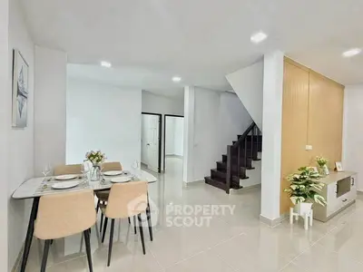 Modern dining area with elegant staircase and stylish decor