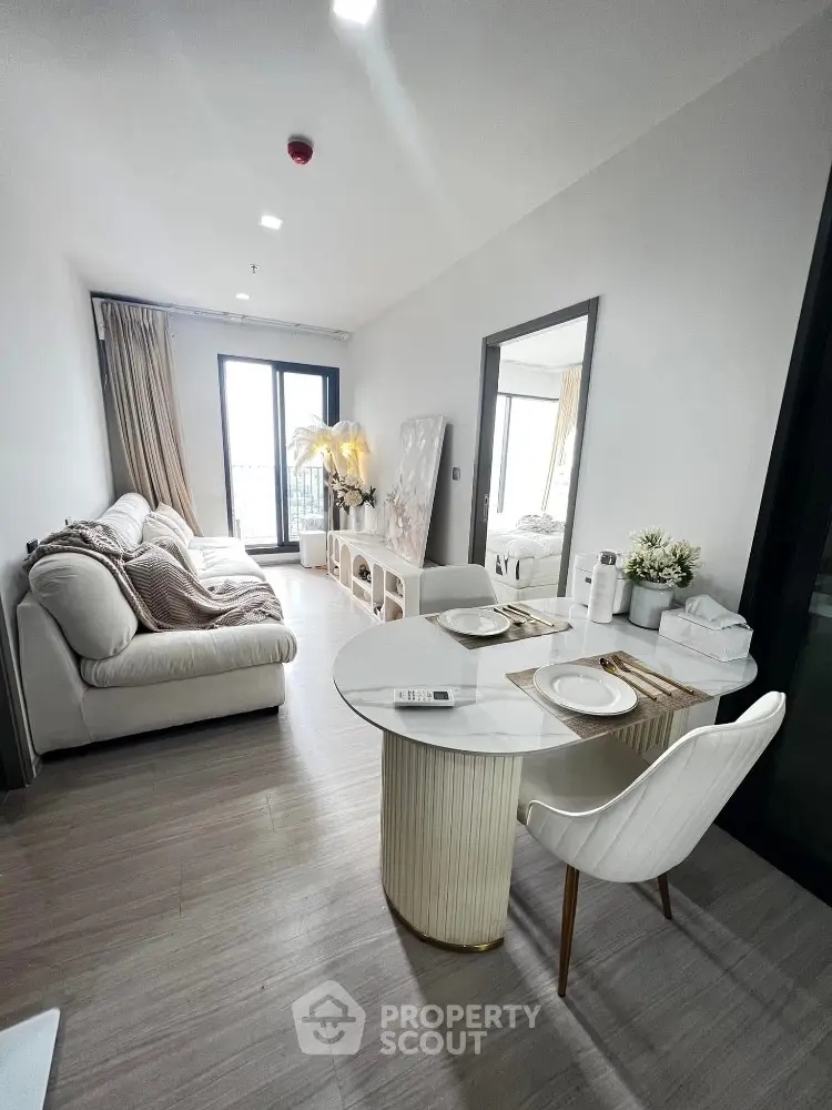 Modern living room with cozy sofa and elegant dining area in open layout apartment