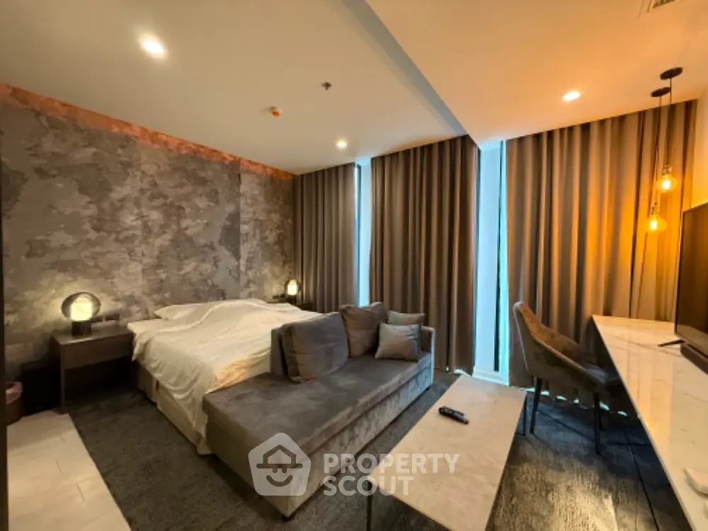 Luxurious modern bedroom with stylish decor and cozy seating area