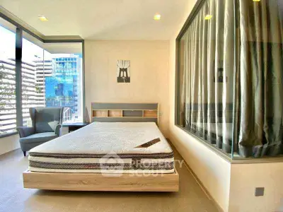 Modern bedroom with large windows and stylish decor in urban apartment