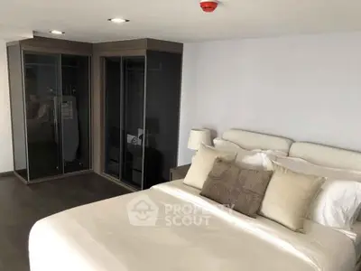 Spacious modern bedroom with sleek wardrobe and cozy bedding