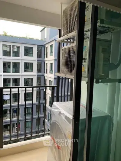 Modern apartment balcony with air conditioning units and city view