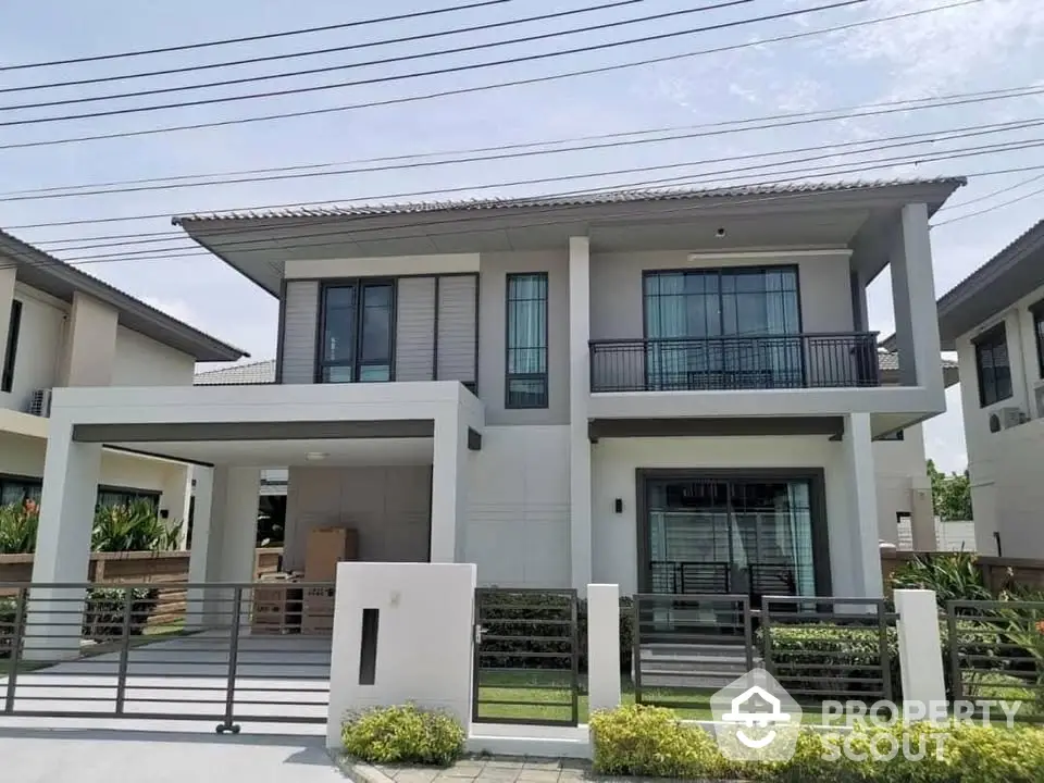 Modern two-story house with sleek design and spacious driveway in a serene neighborhood.