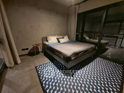 Modern bedroom with large windows and stylish decor in urban apartment.