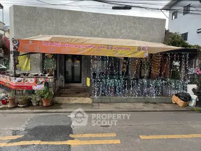 Charming street-side restaurant with festive lights and cozy outdoor seating.