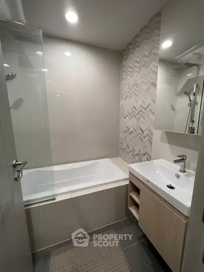 Modern bathroom with bathtub and stylish tile design