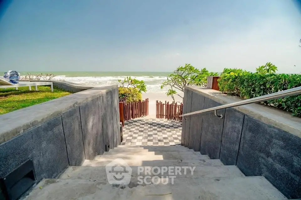 Stunning beachfront property with direct ocean access and lush greenery.