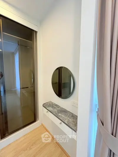 Modern bedroom corner with stylish vanity and round mirror