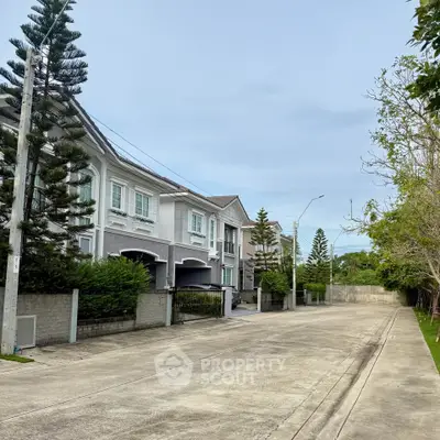 Charming suburban street with elegant townhouses and lush greenery, perfect for family living.