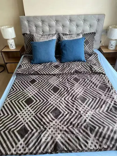 Luxurious bedroom with stylish geometric bedding and elegant decor