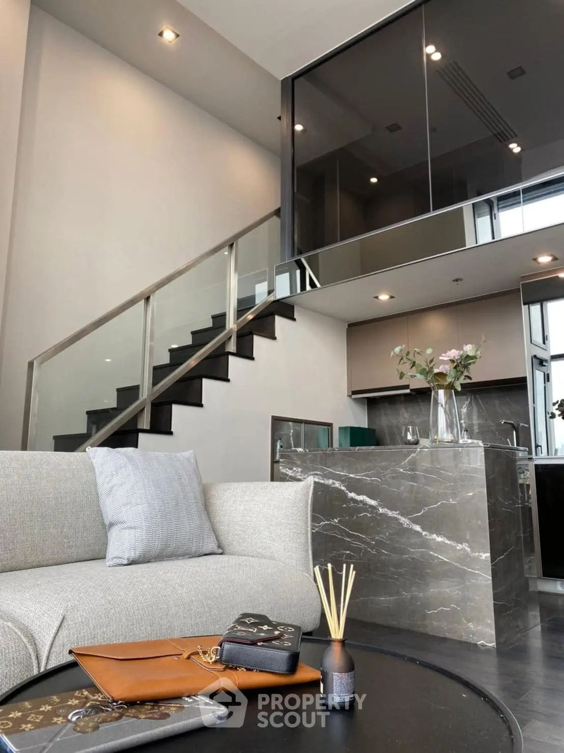 Luxurious modern living room with elegant staircase and stylish kitchen