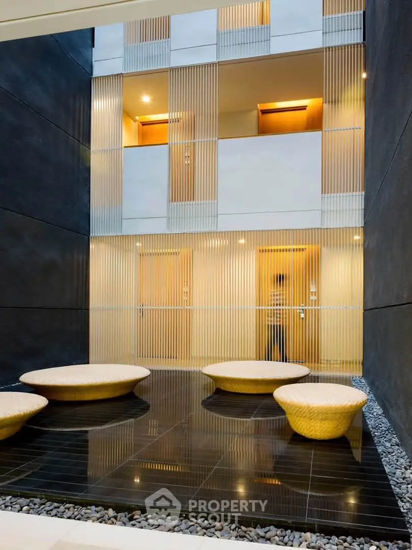 Modern building entrance with stylish seating and sleek design