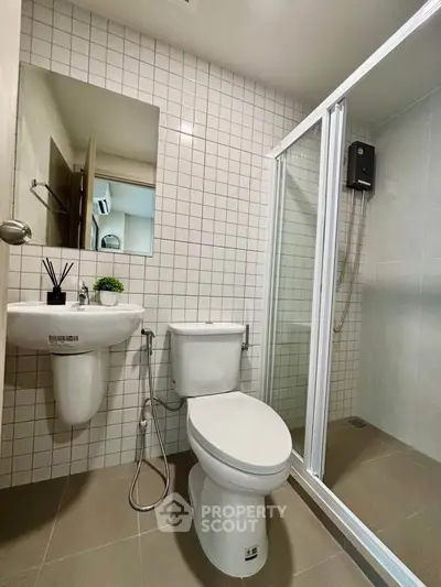 Modern bathroom with sleek shower and contemporary fixtures in a stylish apartment.