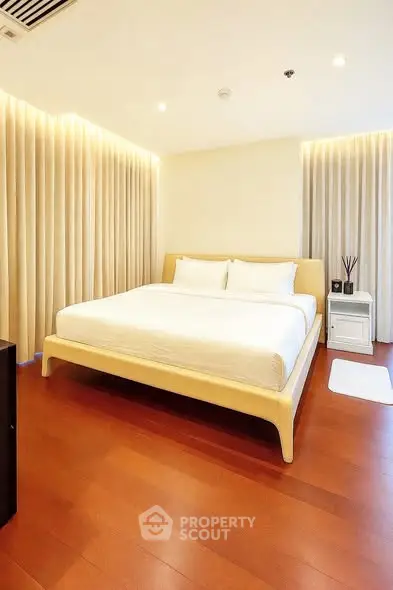 Luxurious bedroom with elegant lighting and wooden flooring