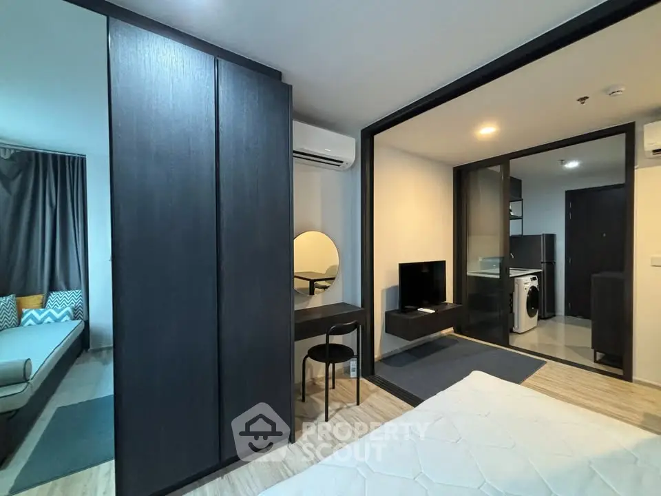 Modern apartment interior with stylish furniture and open layout, featuring a cozy living area and sleek design.