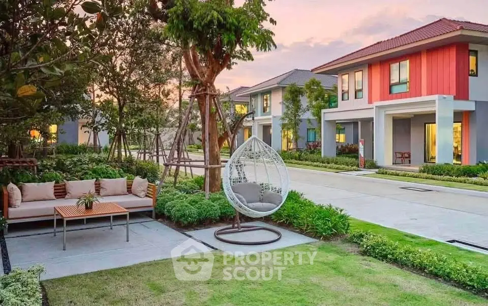 Charming suburban homes with lush gardens and cozy outdoor seating area at sunset.