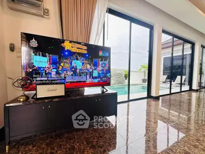 Luxurious living room with pool view and modern entertainment setup