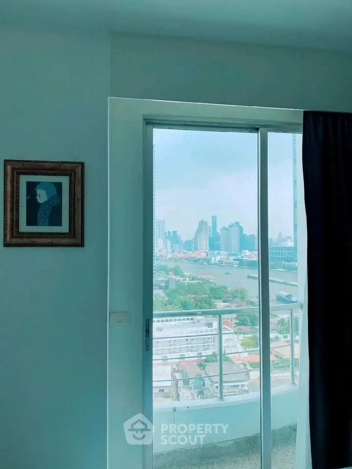 Stunning cityscape view from a modern apartment balcony with large sliding glass doors.