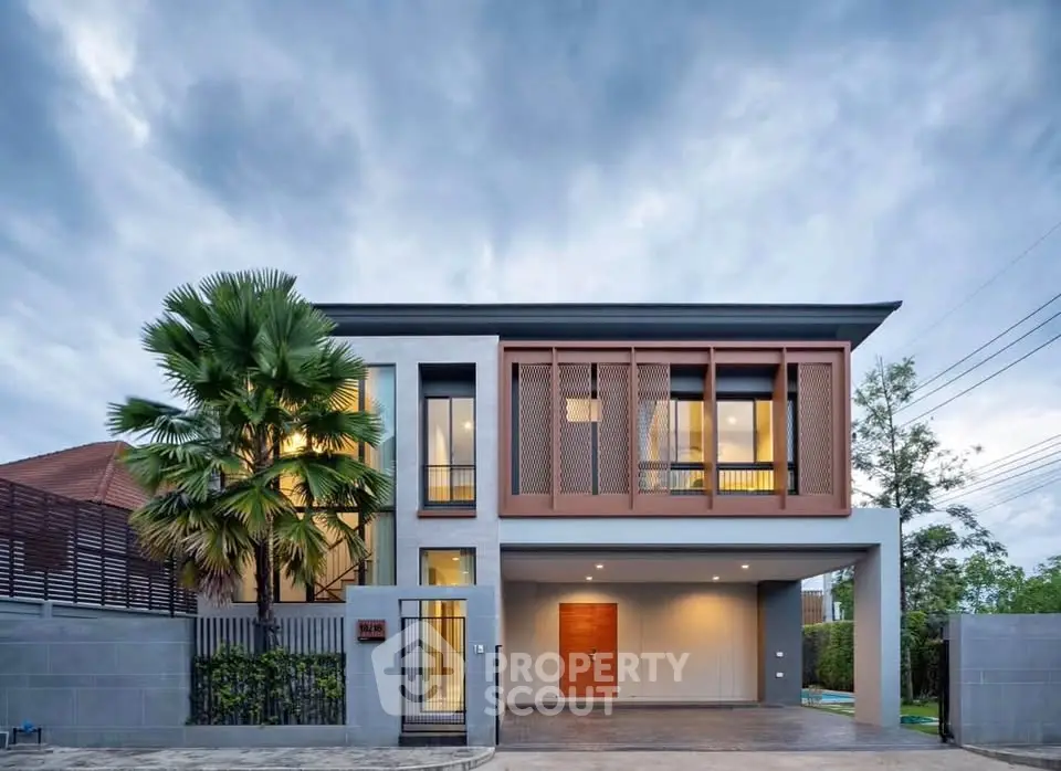 Modern two-story house with sleek design and lush greenery, perfect for contemporary living.